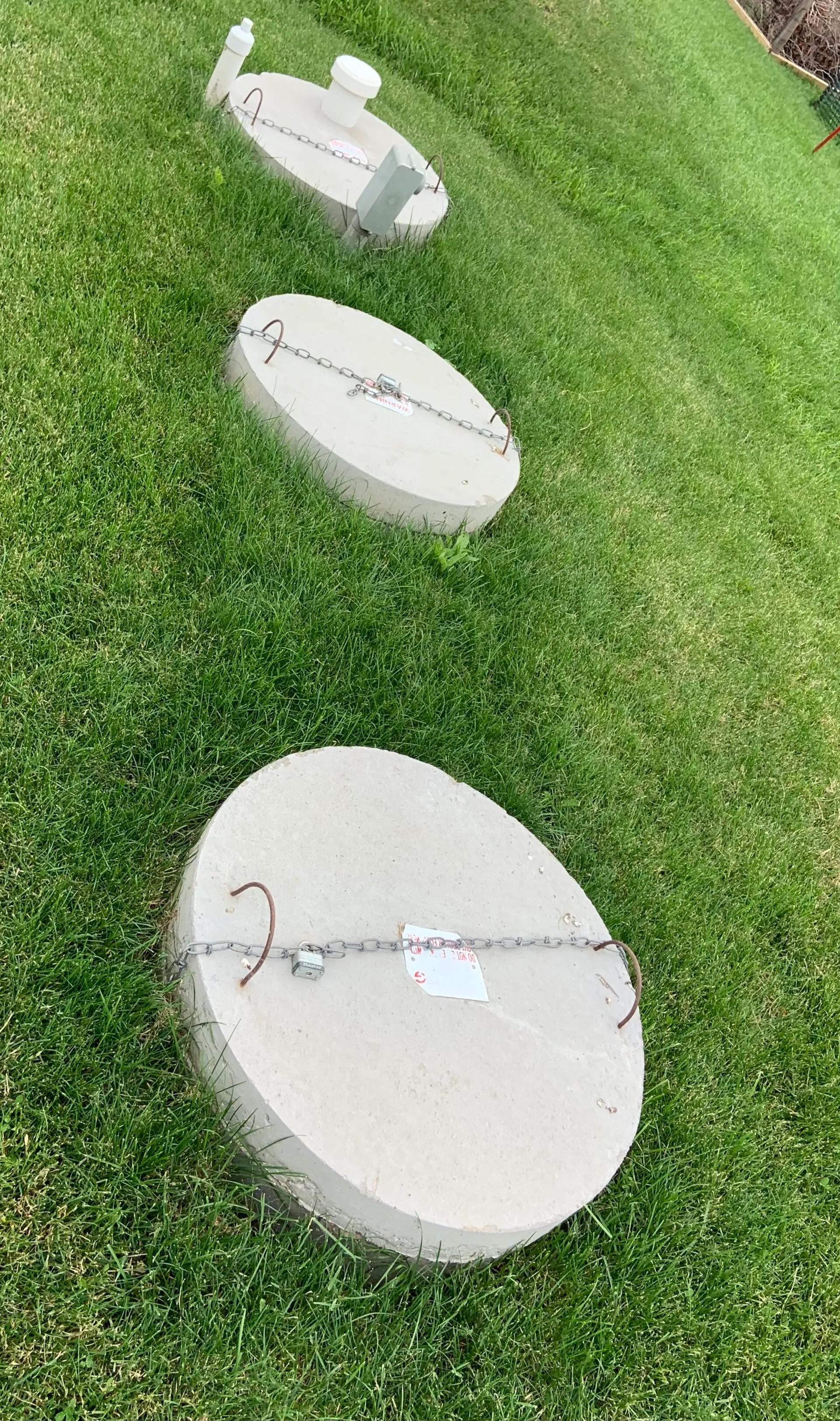 Technician inspecting an aerobic septic system during a home-sale inspection in Comal County, Texas